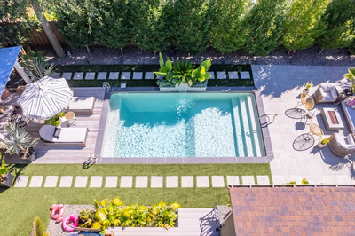Murchison I - Point Pleasant, NJ - A bird's eye view of a backyard with a swimming pool surrounded by greenery and plants