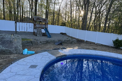 Myojin A - Sparta, NJ - A backyard with a pool and a play area surrounded by trees