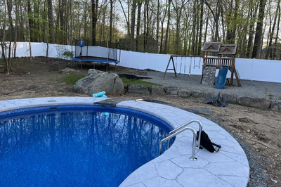 Myojin C - Sparta, NJ - A backyard with a pool and a play area surrounded by trees