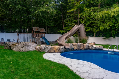 Myojin G - Sparta, NJ - A backyard with a swimming pool and a play structure with a slide