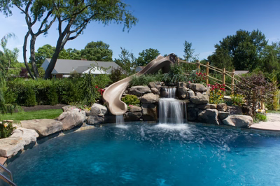 Myrtle B - Vineland, NJ - A swimming pool with a waterfall and a slide in a backyard setting