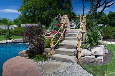 Myrtle D - Vineland, NJ - A backyard with a rock climbing wall and a wooden play structure next to a swimming pool