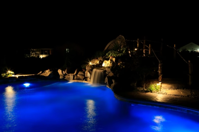Myrtle J - Vineland, NJ - A swimming pool at night with a waterfall in the background
