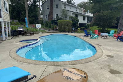 Nachi G - Medford Lakes, NJ - A backyard with a swimming pool and patio furniture.