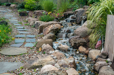Nachi P - Medford Lakes, NJ - A garden path with stepping stones and a stream running through it
