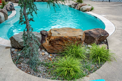 Nachi V - Medford Lakes, NJ - A small swimming pool surrounded by rocks and plants.