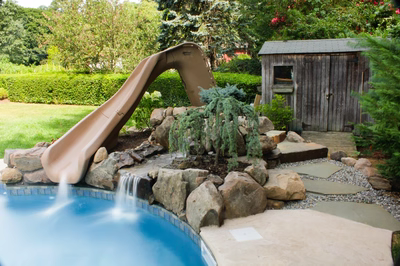 Nena C - Middleton, NJ - A backyard with a water feature and a slide