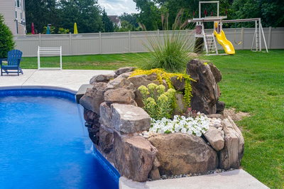 Okere G - Freehold, NJ - A backyard with a swimming pool and a play area with a yellow slide