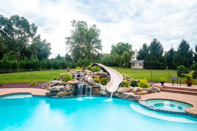 Osawa B - Millstone, NJ - A swimming pool with a water feature and a slide in a backyard setting
