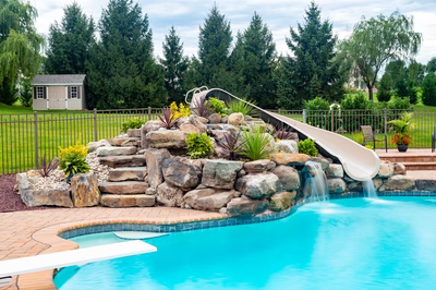 Osawa C - Millstone, NJ - A swimming pool with a water feature and a slide in a backyard setting