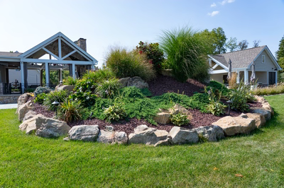Otaki H - Ivyland, PA - A large rock garden in front of a house with a covered porch