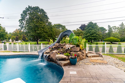 Otodome C - Tinton Falls, NJ - A backyard with a pool and a water feature with a slide