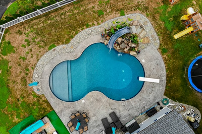 Otodome H - Tinton Falls, NJ - A bird's eye view of a backyard with a swimming pool and a water feature