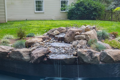 Owen E - Bryn Mawr, PA - A backyard with a water feature surrounded by rocks and plants
