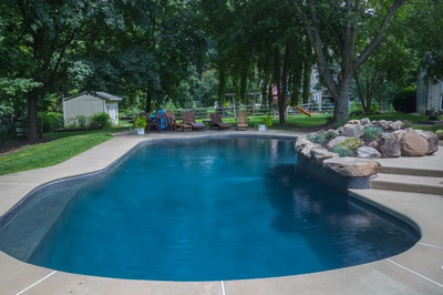 Owen G - Bryn Mawr, PA - A backyard with a swimming pool surrounded by trees and landscaping