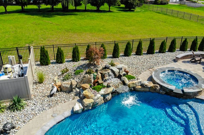 Owharoa D - Swedesboro, NJ - A backyard with a swimming pool and a waterfall feature