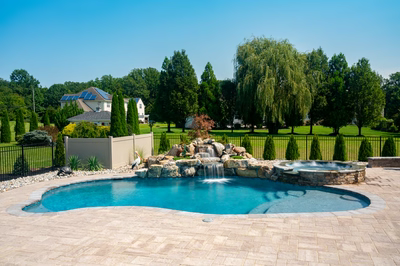 Owharoa F - Swedesboro, NJ - A large backyard with a swimming pool and a waterfall feature