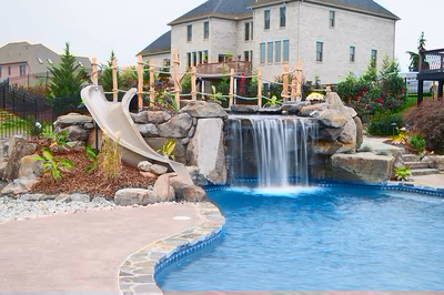 Paluth-C - Two men working on a concrete pool in a backyard.