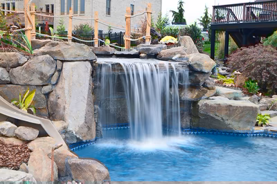 Paluth-D - Two men working on a concrete pool in a backyard.