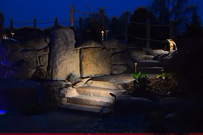 Paluth-L - Two men working on a concrete pool in a backyard.