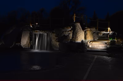 Paluth-O - Two men working on a concrete pool in a backyard.