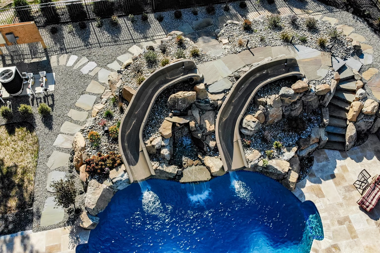 Brown I - Forrest Hills, MD - A bird's eye view of a backyard with a swimming pool and a waterfall feature