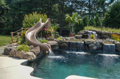Paradise A - Moorestown, NJ - A backyard pool with a water feature and a slide
