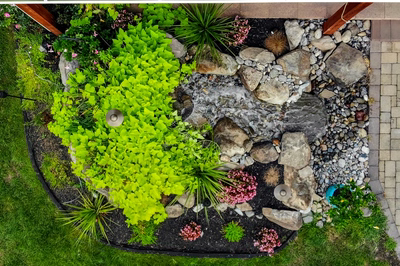 Paulina F - Williamstown, NJ - A bird's eye view of a garden with a small waterfall surrounded by plants and flowers