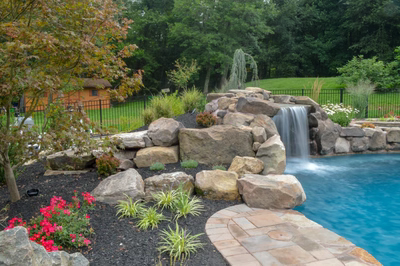Prenn C - Limerick, PA - A backyard with a waterfall and landscaping around a swimming pool