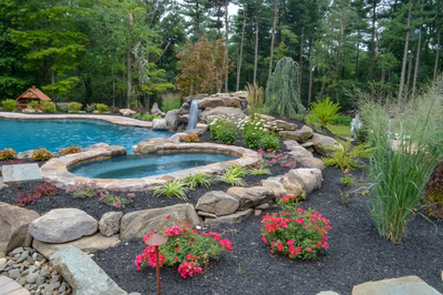 Prenn F - Limerick, PA - A beautiful backyard with a swimming pool surrounded by lush greenery and flowers