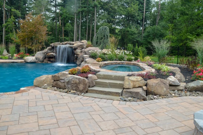 Prenn G - Limerick, PA - A beautiful backyard with a pool and waterfall surrounded by lush greenery