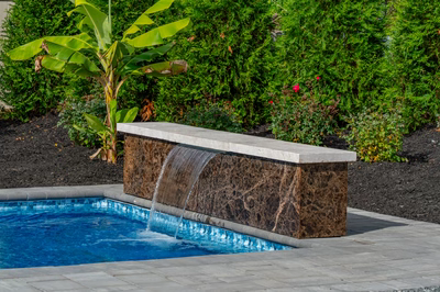 Formal B - Forrest Hills, MD - A rectangular pool with a waterfall feature in the middle surrounded by lush greenery