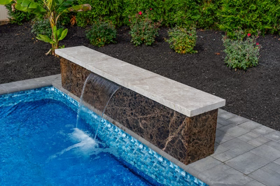 Formal B - Forrest Hills, MD - A small pool with a waterfall in the middle of it surrounded by plants and flowers