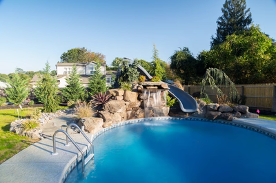 Rainbow A - Middletown, NJ - A backyard with a swimming pool and a waterfall feature