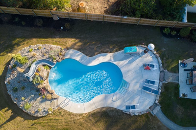 Rainbow D - Middletown, NJ - A bird's eye view of a backyard with a swimming pool and a water feature