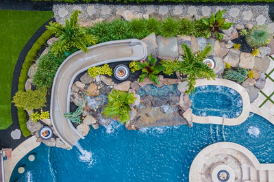 Richetli M - Monroe, NJ - A bird's eye view of a swimming pool surrounded by lush greenery and a water feature