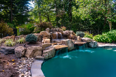 Ripon H - Red Bank, NJ - A natural swimming pool with a waterfall surrounded by lush greenery