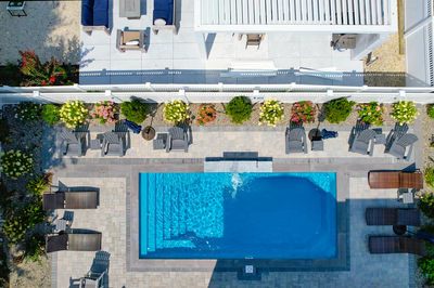 Rome I - Long Beach Island, NJ - A bird's eye view of a backyard with a swimming pool surrounded by plants and furniture