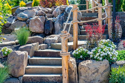 Russell G - Maple Shade, NJ - A set of stone stairs leading up to a rocky garden with rope barriers and colorful flowers