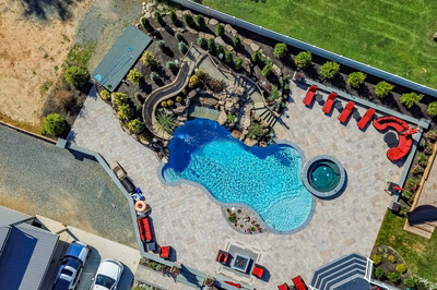 Russell L - Maple Shade, NJ - A bird's eye view of a backyard with a swimming pool surrounded by landscaping