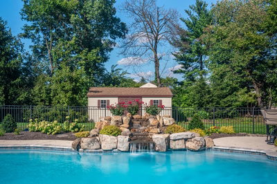 Ryuzu B - Collegeville, PA - A swimming pool with a waterfall and a small house in the background