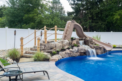 Sansa B - Forked River, NJ - A backyard with a pool and a water feature with a slide