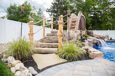 Sansa C - Forked River, NJ - A backyard with a water feature and a play structure