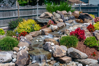 Sendo C - Sewell, NJ - A rock garden with a small waterfall surrounded by colorful flowers