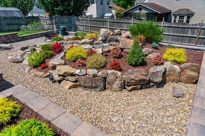 Sendo F - Sewell, NJ - A rock garden with a waterfall and colorful flowers in a backyard setting