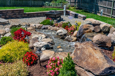Sendo G - Sewell, NJ - A garden with a small stream running through it surrounded by rocks and flowers