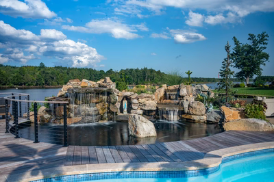 Shebelle - Hammonton, NJ - A beautiful outdoor swimming pool with a waterfall feature and a wooden deck