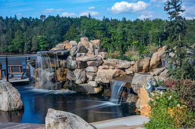 Shebelle - Hammonton, NJ - A beautiful outdoor pond with a waterfall surrounded by rocks and greenery