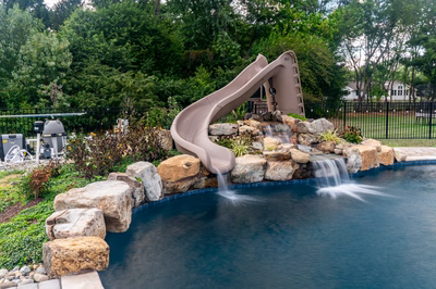 Shomyo D - Princeton Junction, NJ - A swimming pool with a water feature and a slide in a backyard setting