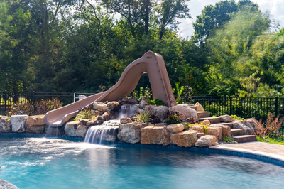 Shomyo E - Princeton Junction, NJ - A pool with a water feature and a slide in the middle of it
